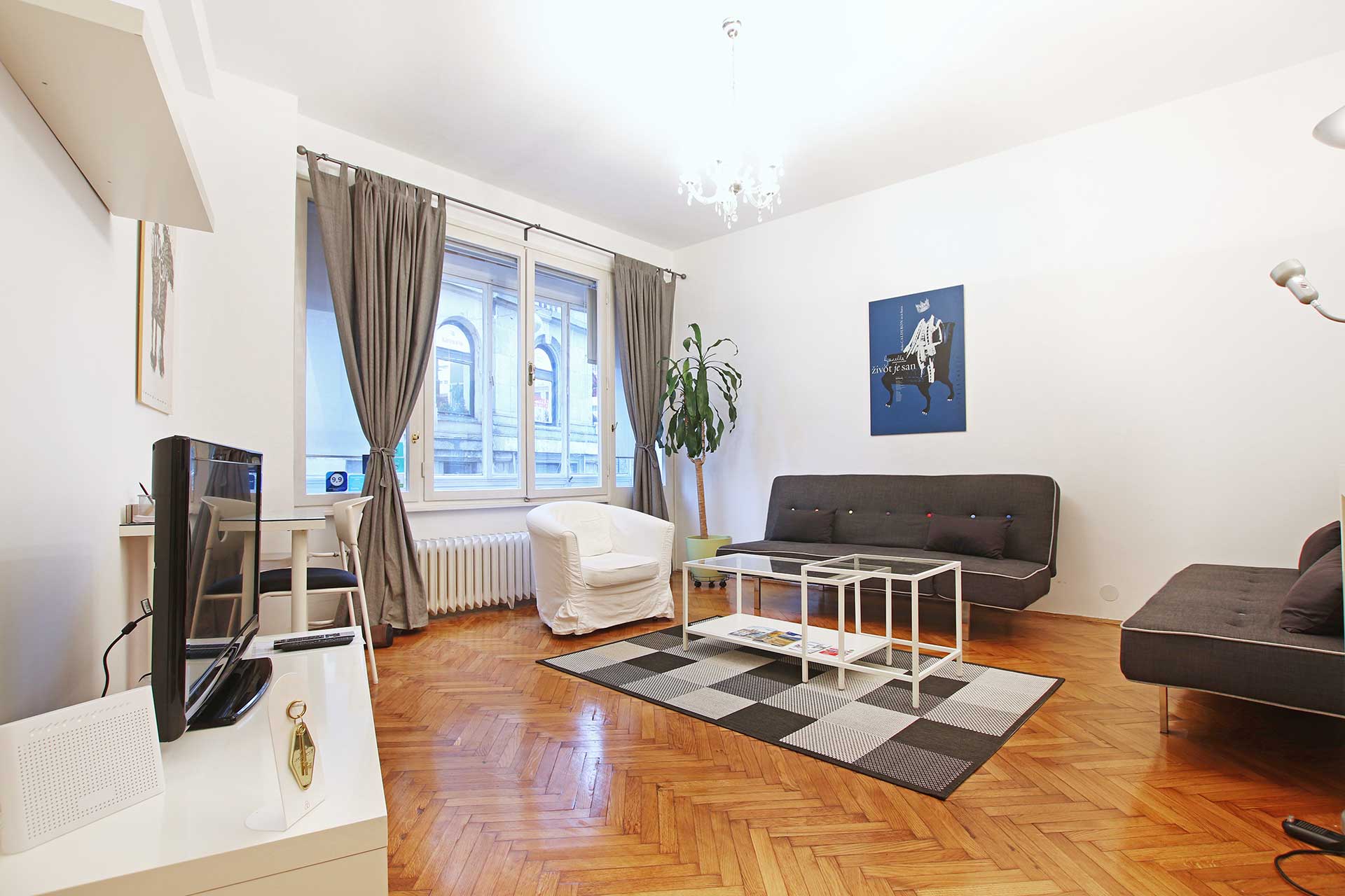 Living room of the Main Square Zagreb Apartment, with parquet floor and tall windows