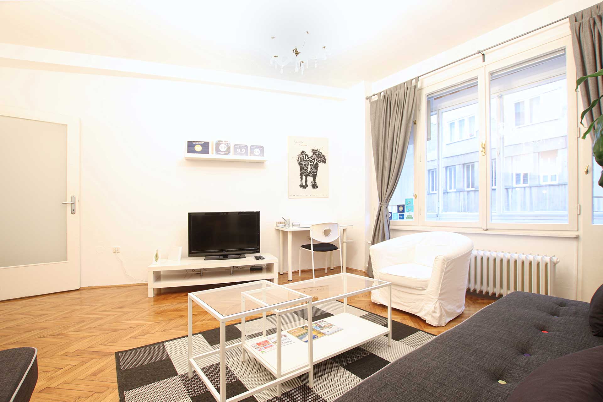 Living room with sofa, coffee table and parquet floor